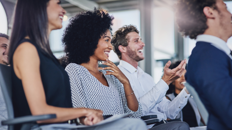 woman and man listening to a speaker