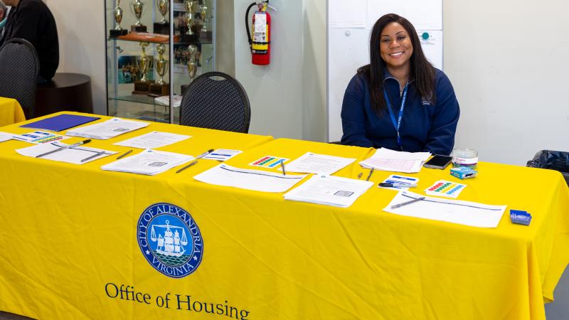 woman smiling at camera behind table
