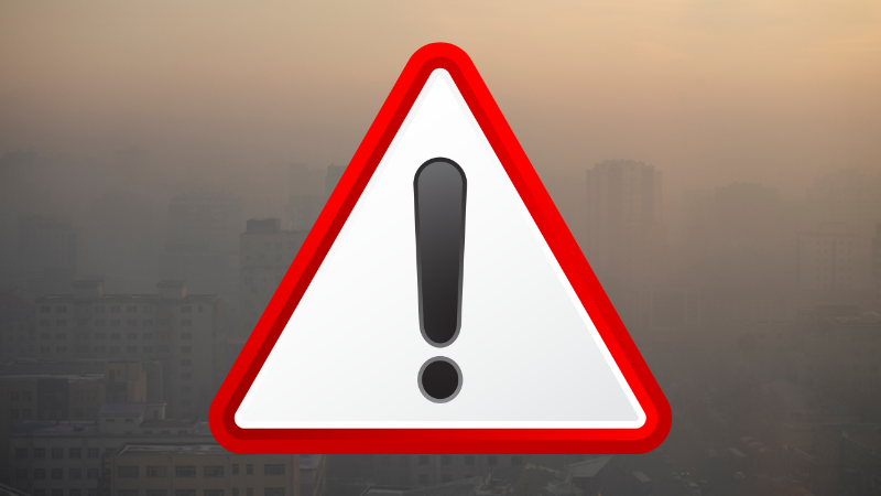 triangle with exclamation point and picture of smoky scene in background